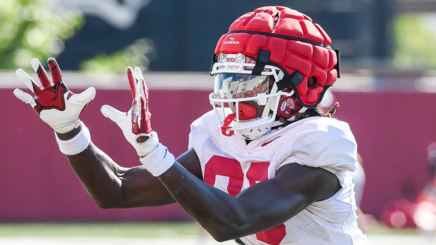 Razorbacks wide receiver Davian Dozier catches a pass during practice drills on the outdoor practice fields in Fayetteville